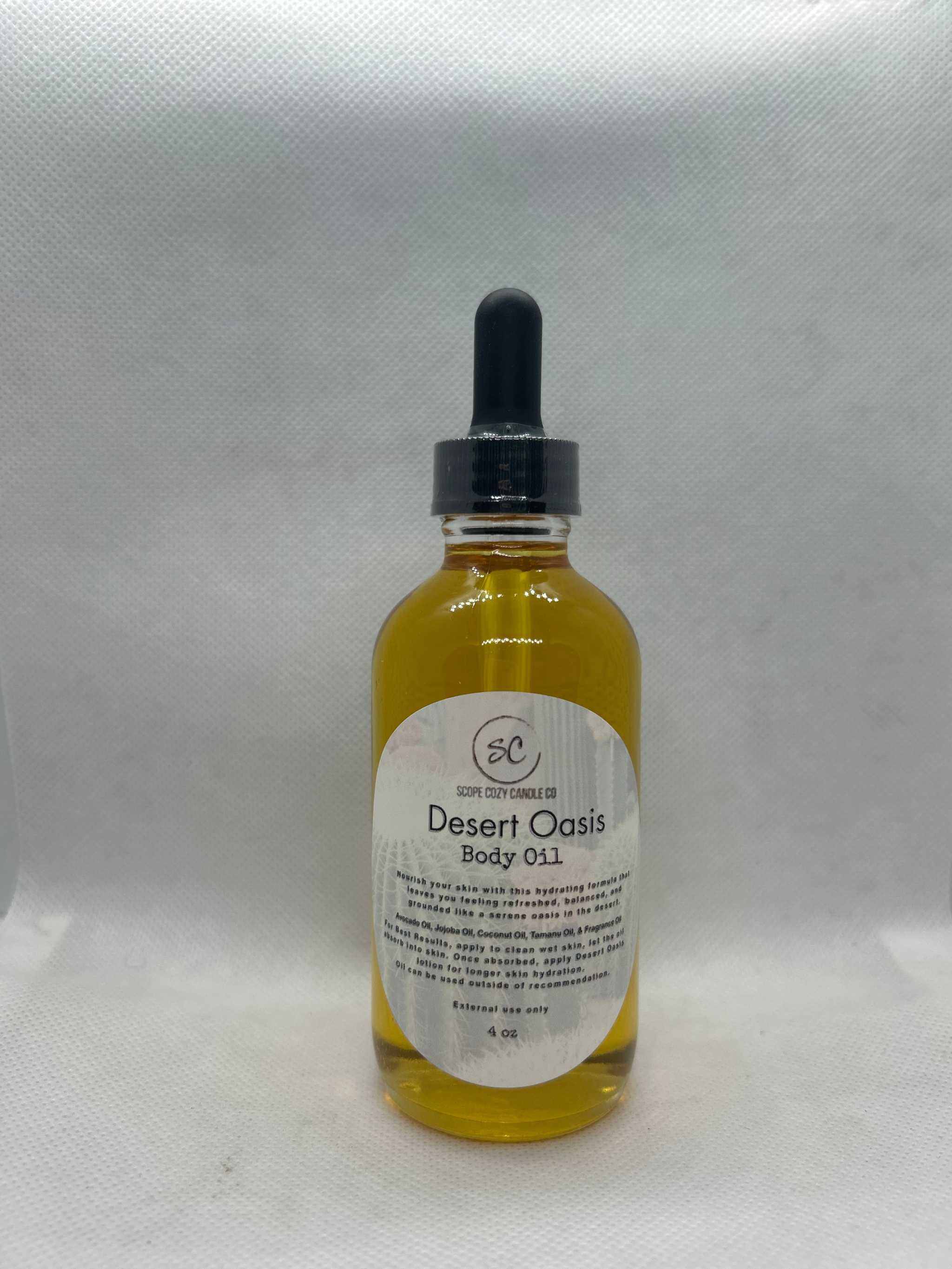 Bottle of Desert Oasis Body Oil 4oz with dropper cap on white background
