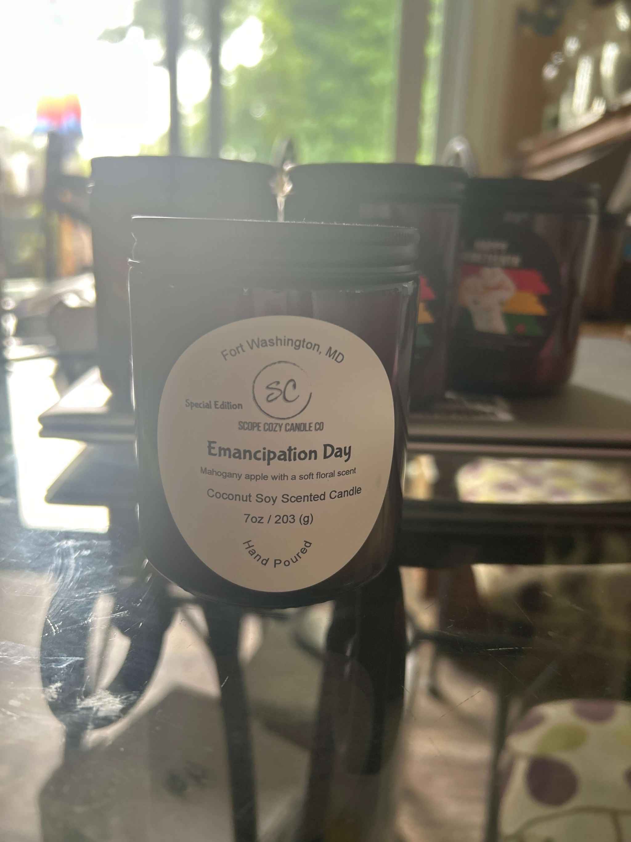 Emancipation Day Coconut soy wax candle with mahogany apple and floral scents in a 7oz jar