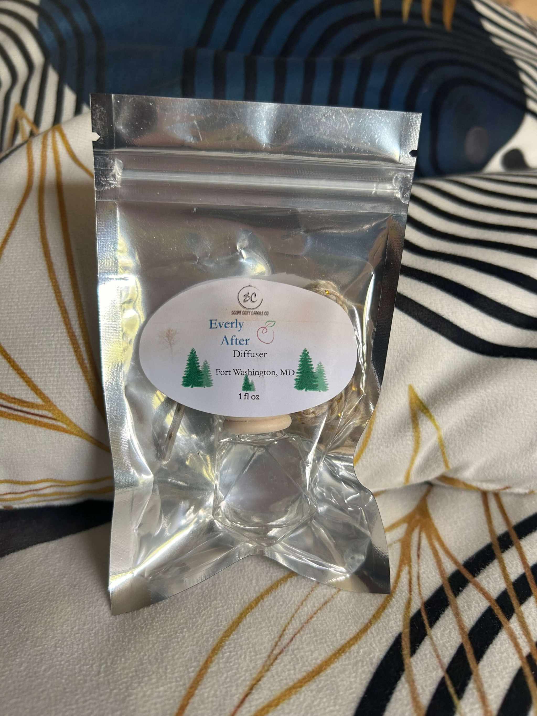 Every After Diffuser 1oz in silver resealable pouch with pine and cedar wood scent