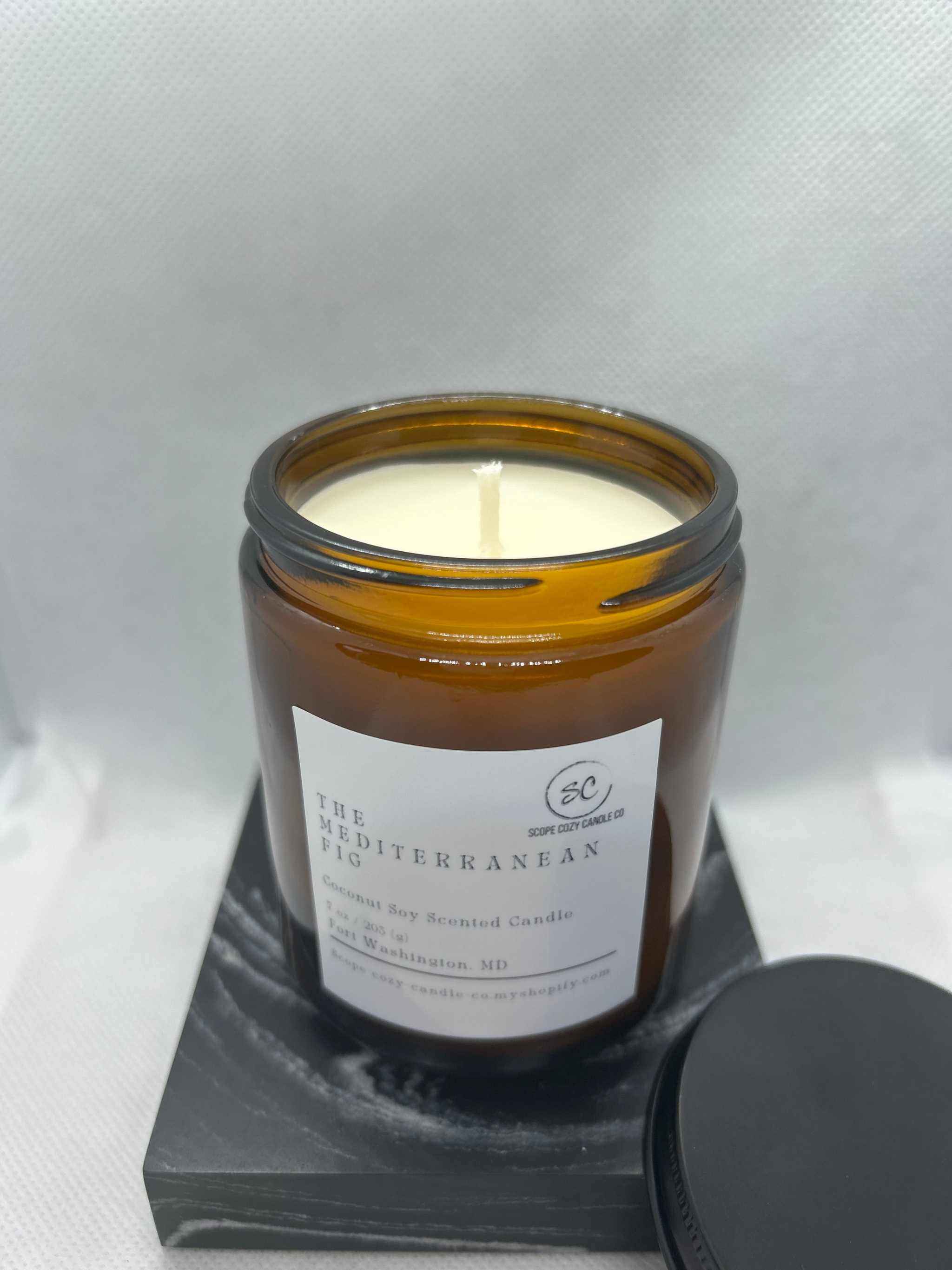 Mediterranean Fig Coconut Soy Candle 7 oz in amber jar with lid on marble base