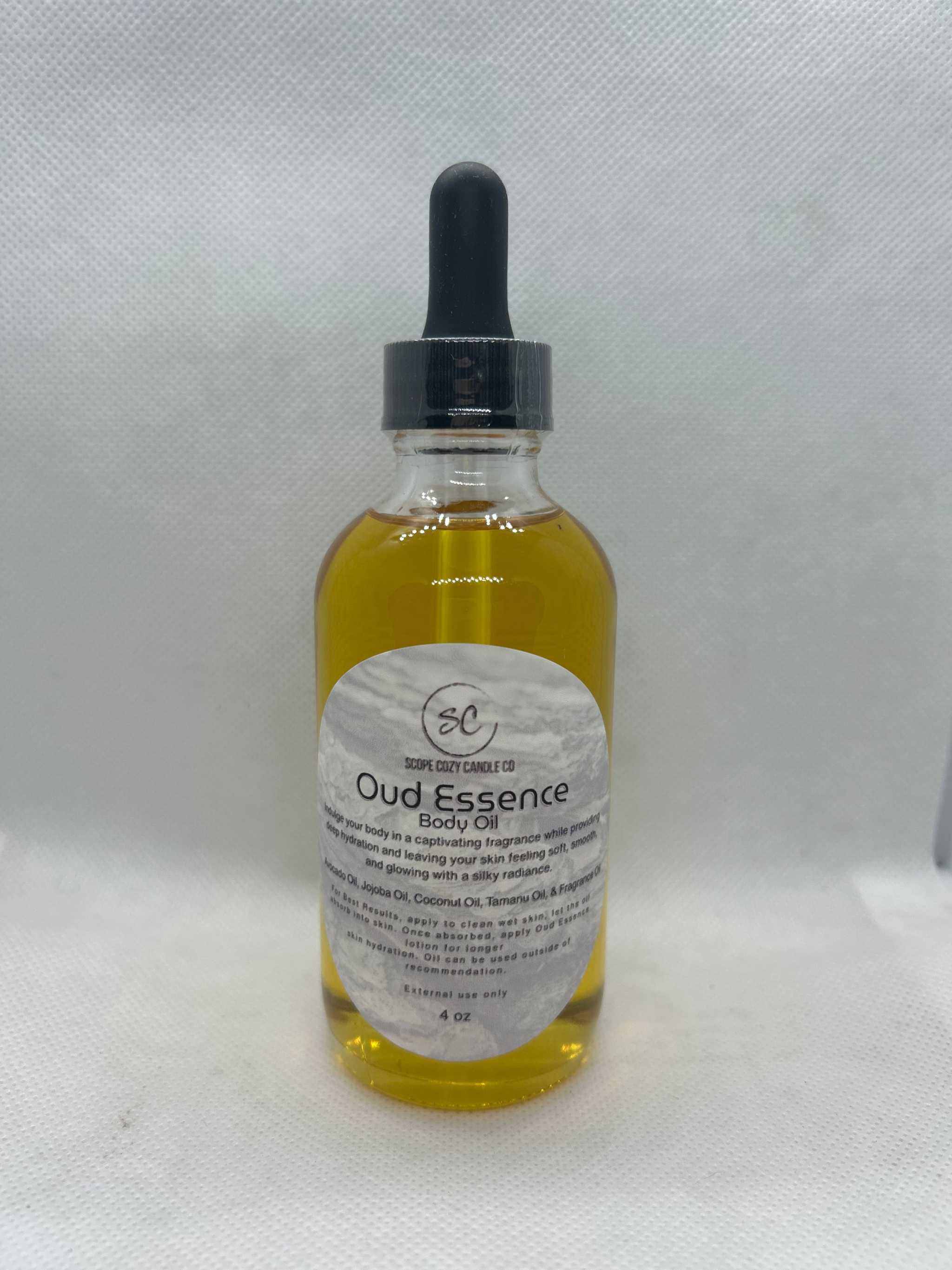 Oud Essence Body Oil 4oz bottle with dropper, moisturizing blend of avocado, jojoba, tamanu, and coconut oils with tonka and oud fragrance