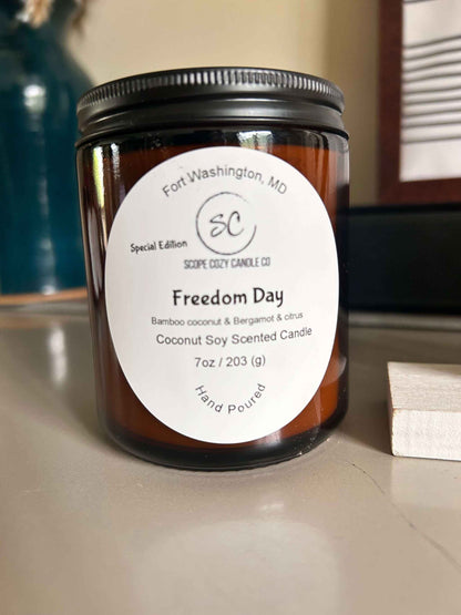 Freedom Day Coconut soy scented candle with bamboo, bergamot, citrus, and cedar wood notes in a 7oz amber jar