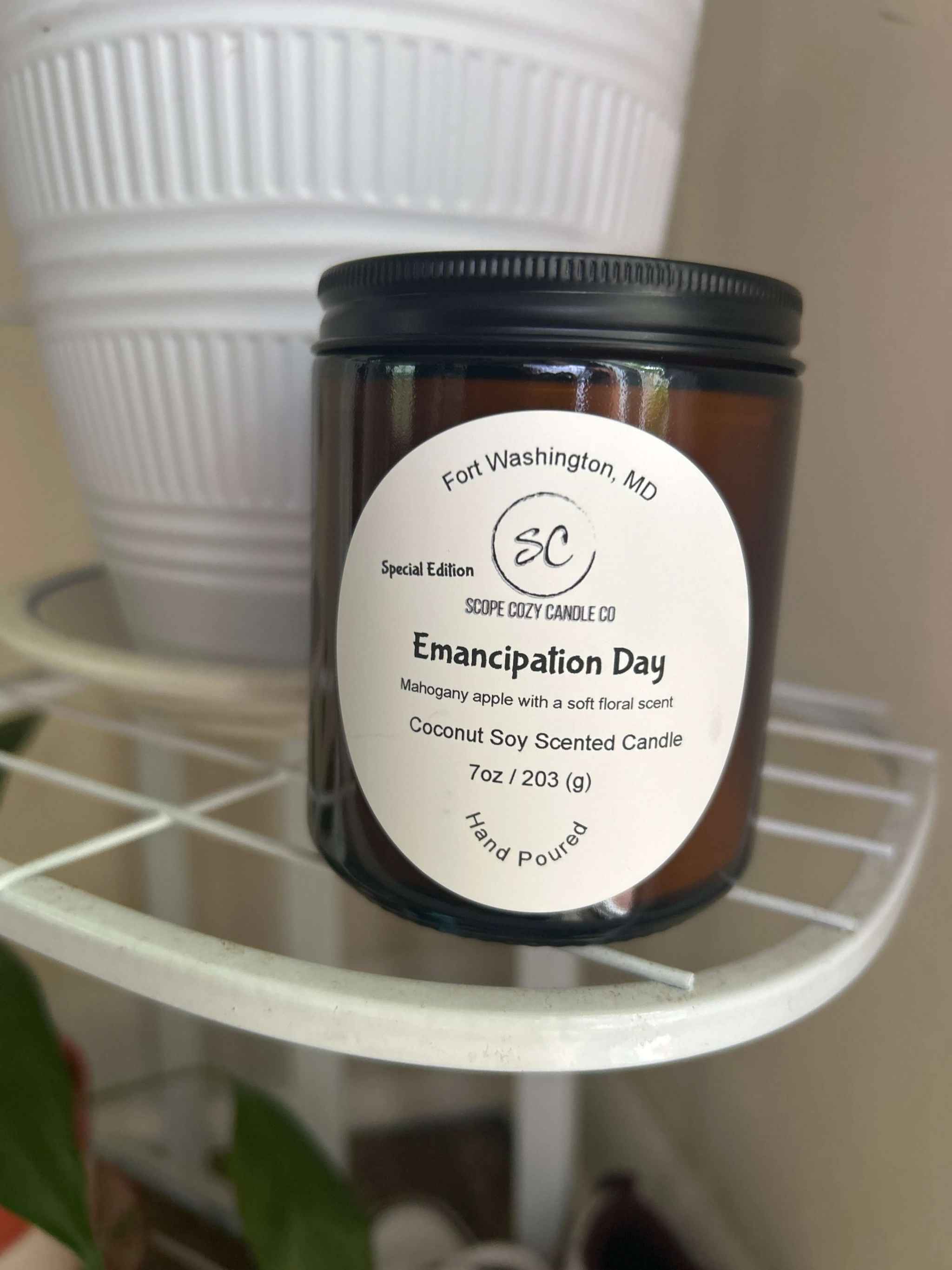 Emancipation Day Coconut soy wax candle with mahogany apple and floral scent in 7oz amber jar
