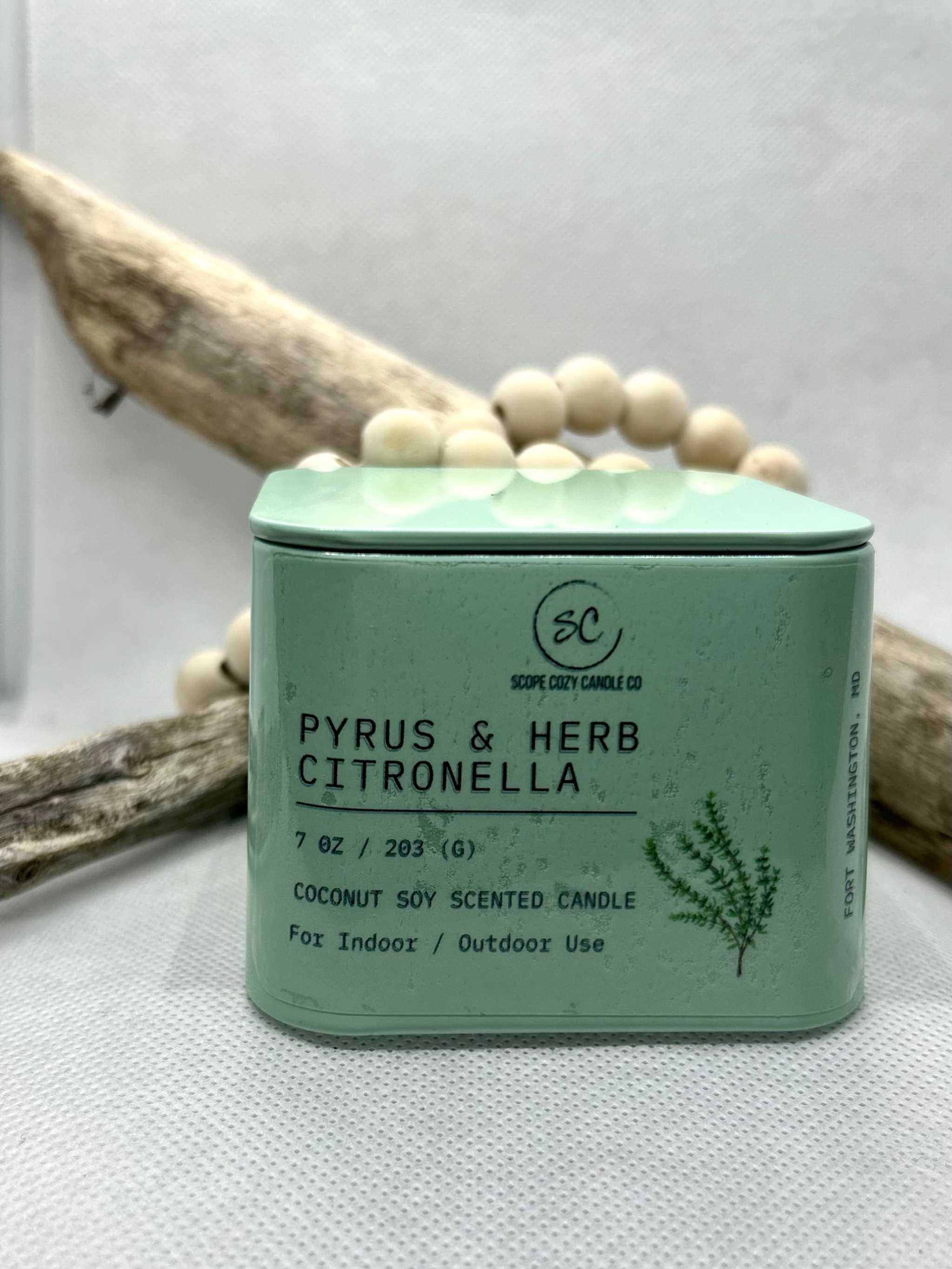 Pyrus &amp; Herb Citronella scented coconut soy candle in green tin for indoor and outdoor use with pear, thyme, and sage notes