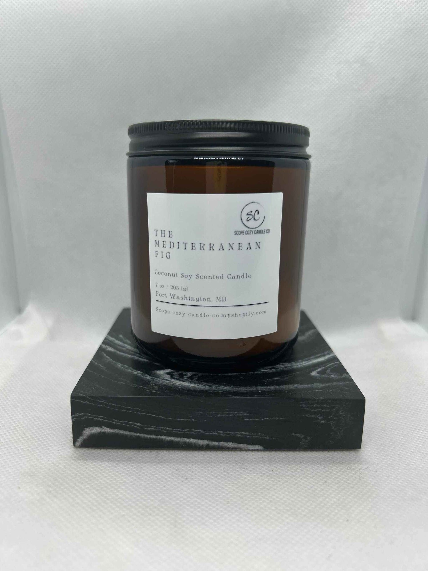 Mediterranean Fig Coconut Soy Candle 7 oz in amber jar on black marble base