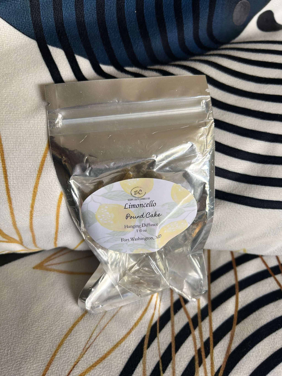 Limoncello Pound Cake Diffuser in clear sealed bag with decorative label on patterned fabric background