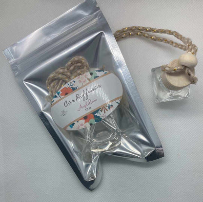 Angel Rossa car diffuser with floral tropical scent featuring citrus, mango, berries, and pineapple notes in a clear glass bottle with braided hanging rope.