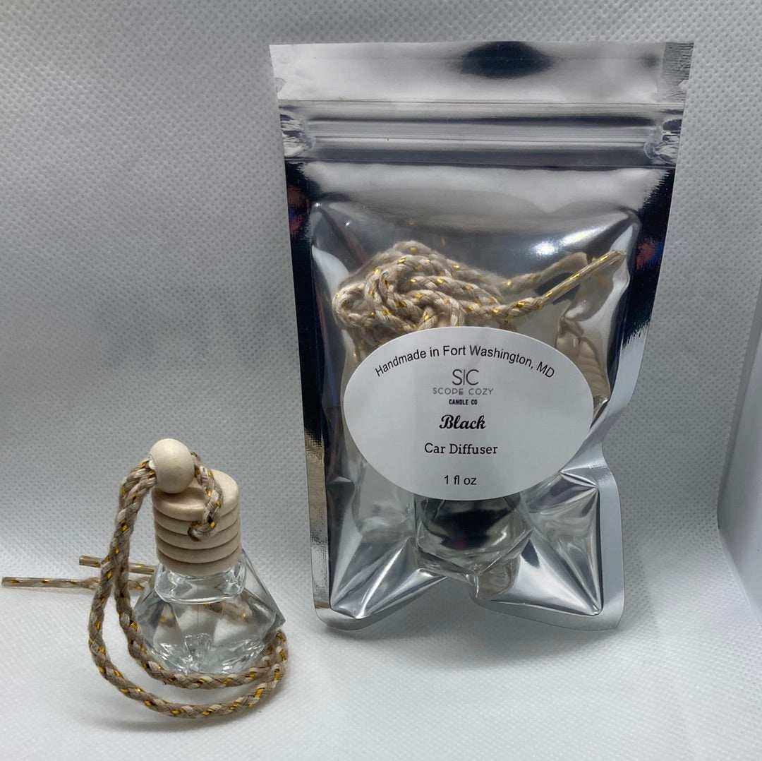 Black hanging diffuser with wooden cap and braided rope, packaged in a silver resealable bag, scented with black cardamom, baby powder, and white musk fragrance for cars or small spaces.